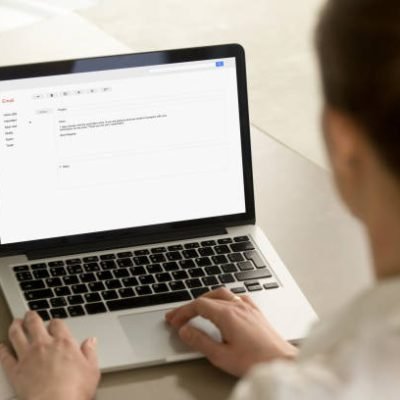 istockphoto-855752984-612x612 Businesswoman typing e-mail on laptop at office desk, composing professional email letter using business etiquette, writing e message to corporate client online, focus on screen, close up rear view